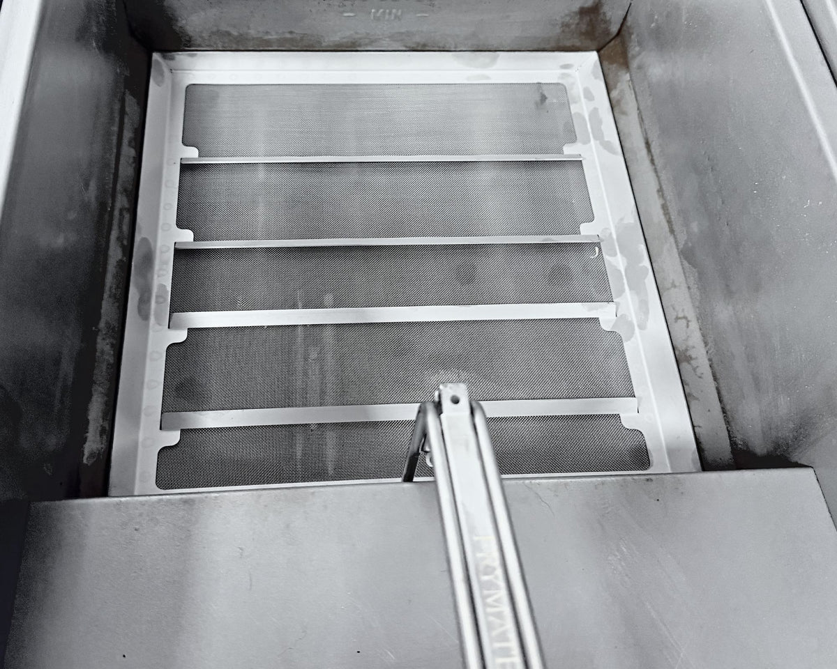 Clean Frymate filter tray sitting at the bottom of a fryer