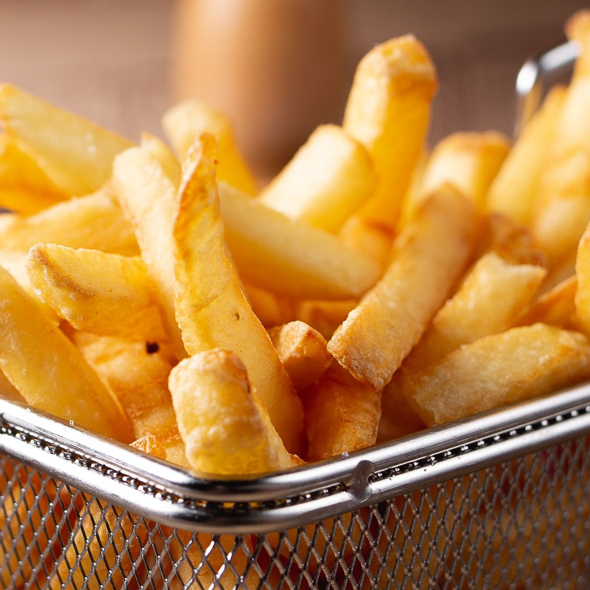 Golden fries in a fryer basket