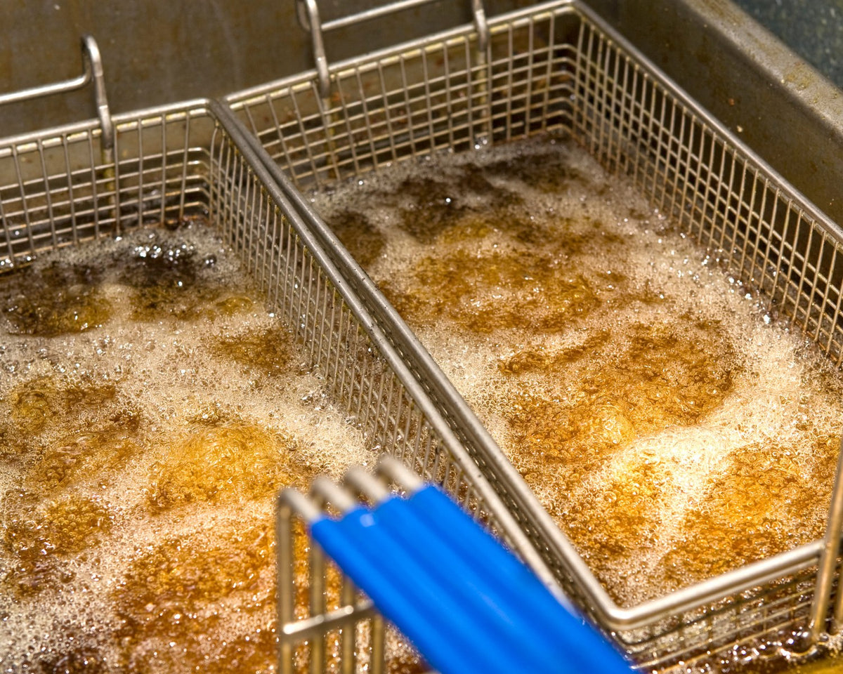Fryer baskets in bubbling oil